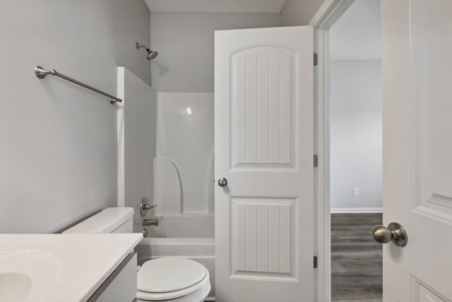 full bathroom with hardwood / wood-style floors, vanity, toilet, and bathtub / shower combination