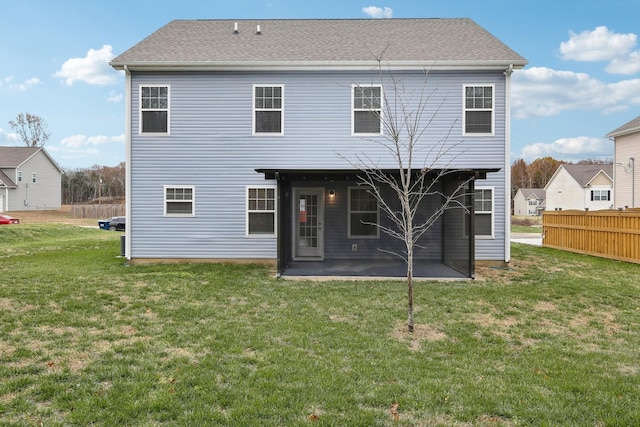 rear view of property with a lawn and a patio area