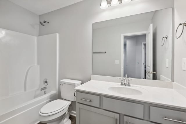 full bathroom featuring vanity, bathtub / shower combination, and toilet