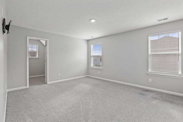 unfurnished room with light colored carpet