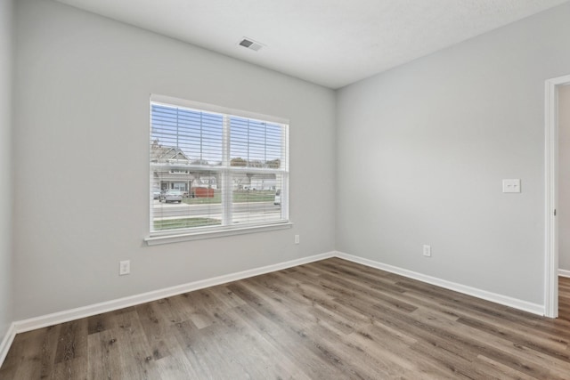 unfurnished room featuring hardwood / wood-style floors