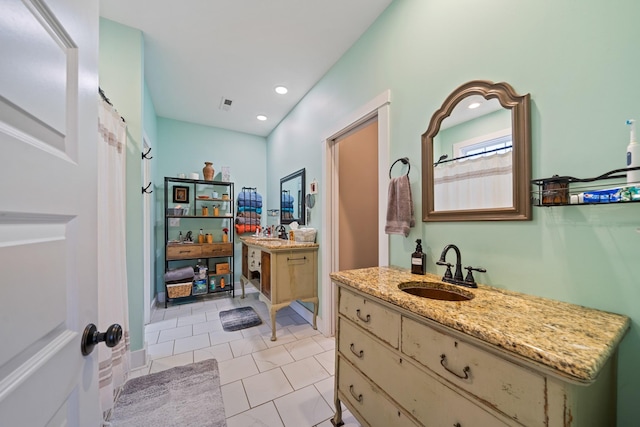 bathroom with tile patterned floors and vanity