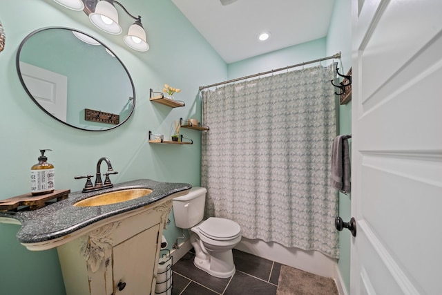 bathroom featuring tile patterned flooring, vanity, and toilet