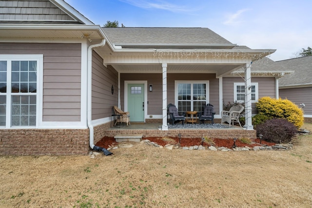 property entrance with a lawn and a porch