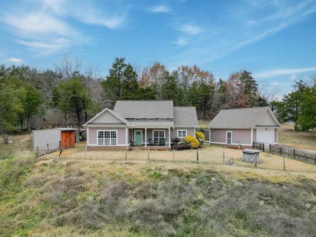 back of property with a porch and a shed