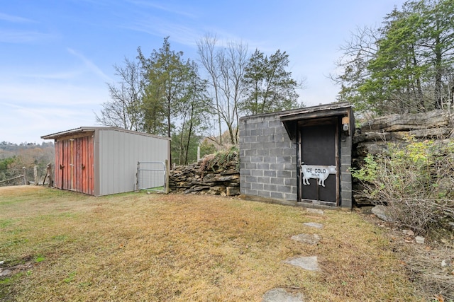 view of outbuilding featuring a yard