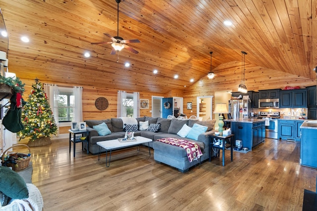 living room with wood ceiling, wood walls, light wood-type flooring, and high vaulted ceiling