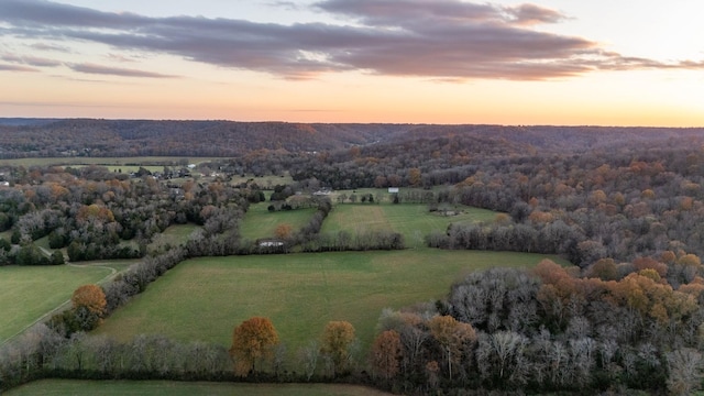 aerial view at dusk featuring a rural view