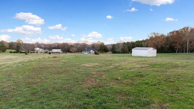 view of yard featuring an outbuilding and a rural view