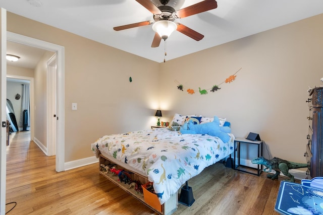 bedroom with ceiling fan and wood-type flooring