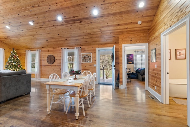 dining room featuring hardwood / wood-style flooring, wood ceiling, and high vaulted ceiling