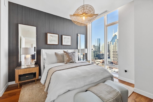 bedroom featuring hardwood / wood-style flooring and multiple windows