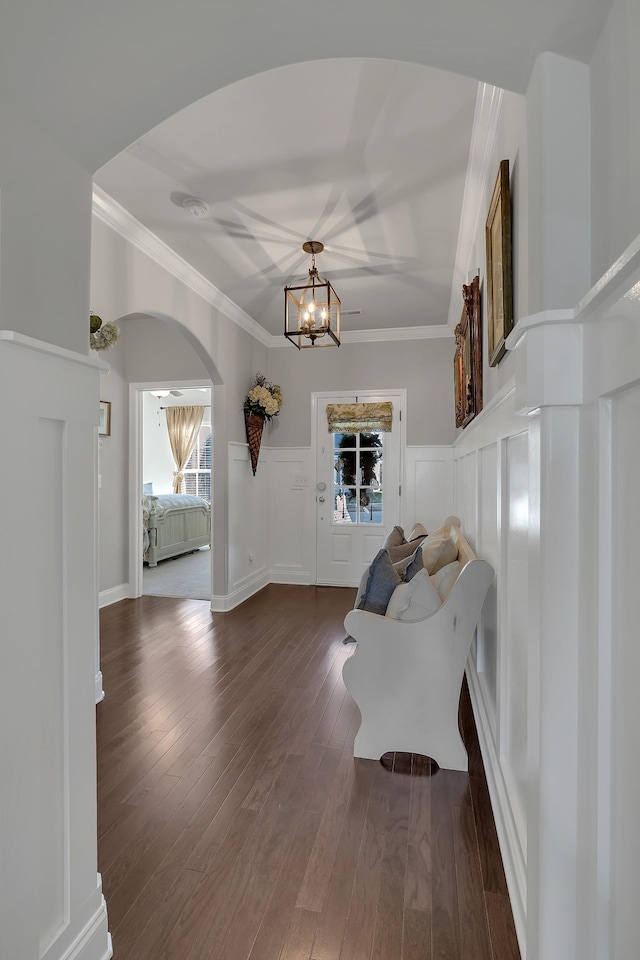 interior space featuring dark hardwood / wood-style floors, an inviting chandelier, plenty of natural light, and crown molding