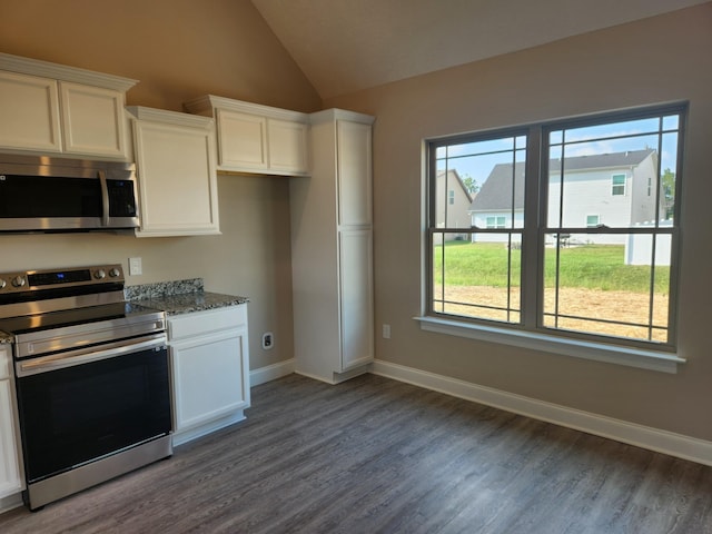 kitchen with white cabinets, dark stone counters, plenty of natural light, and stainless steel appliances