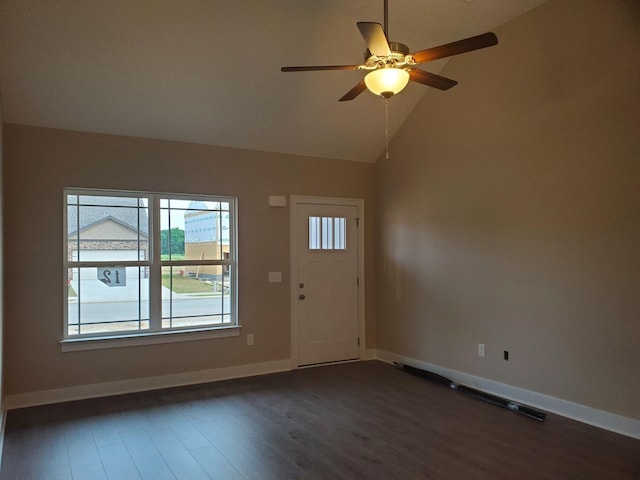 foyer with ceiling fan, dark hardwood / wood-style flooring, and vaulted ceiling