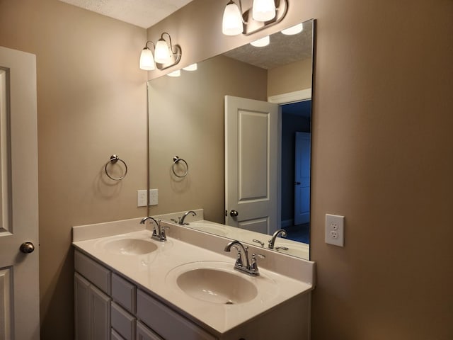 bathroom featuring a textured ceiling and vanity