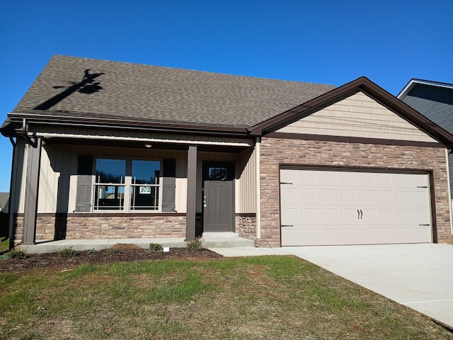 view of front of property with a front lawn and a garage