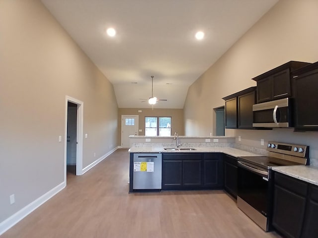 kitchen with ceiling fan, kitchen peninsula, sink, and stainless steel appliances