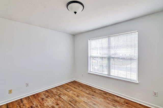 spare room with hardwood / wood-style flooring