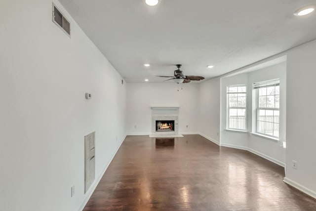 unfurnished living room featuring ceiling fan and dark hardwood / wood-style floors