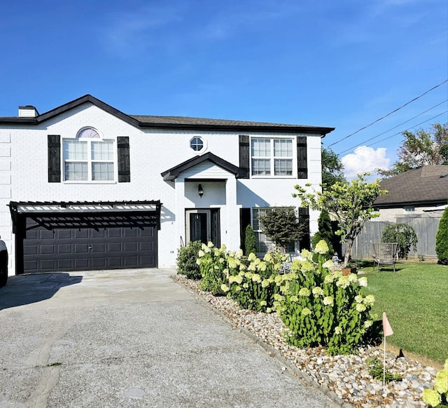 view of front of house featuring a front yard and a garage