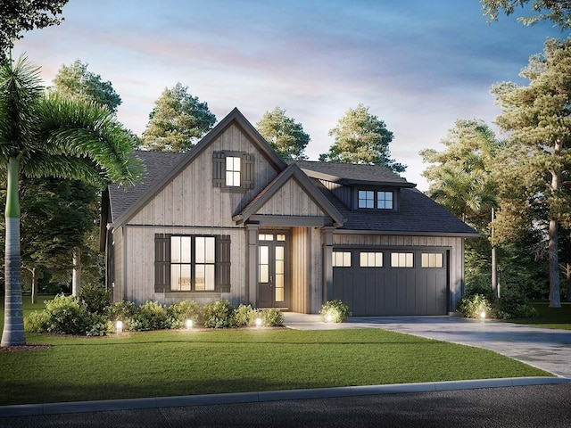 view of front of house with a garage and a yard