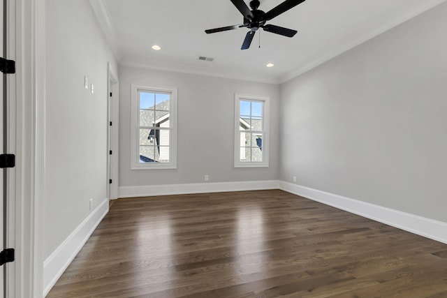 empty room with ceiling fan, dark hardwood / wood-style flooring, and crown molding