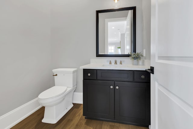 bathroom with vanity, wood-type flooring, and toilet