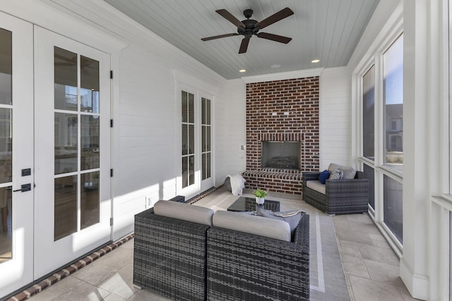 exterior space featuring an outdoor living space with a fireplace and ceiling fan