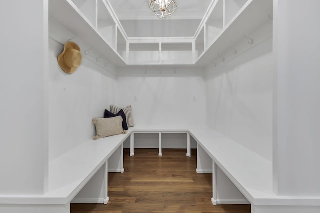 mudroom featuring dark wood-type flooring and an inviting chandelier