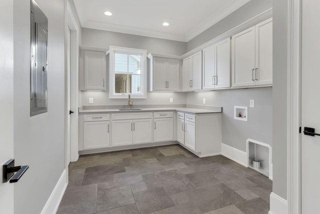 laundry area with cabinets, washer hookup, ornamental molding, sink, and electric panel