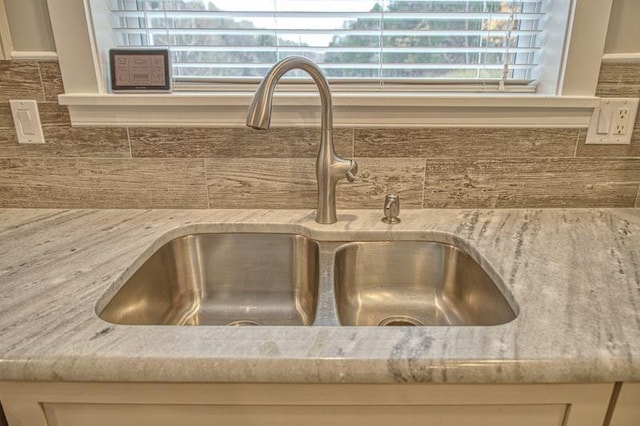 interior details with light stone countertops and sink