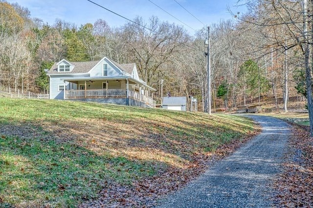 view of front facade featuring covered porch and a front yard