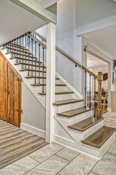 staircase with hardwood / wood-style flooring