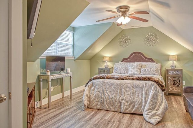 bedroom with wood-type flooring, vaulted ceiling, and ceiling fan