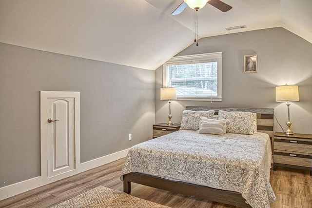 bedroom featuring ceiling fan, vaulted ceiling, and hardwood / wood-style flooring