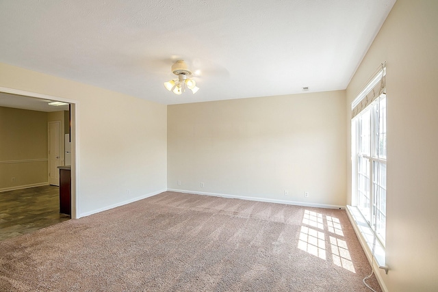 carpeted empty room featuring ceiling fan