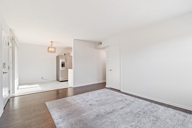 empty room with dark hardwood / wood-style flooring