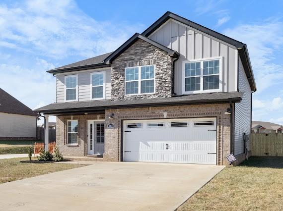 view of front of house featuring a garage, a porch, and a front lawn