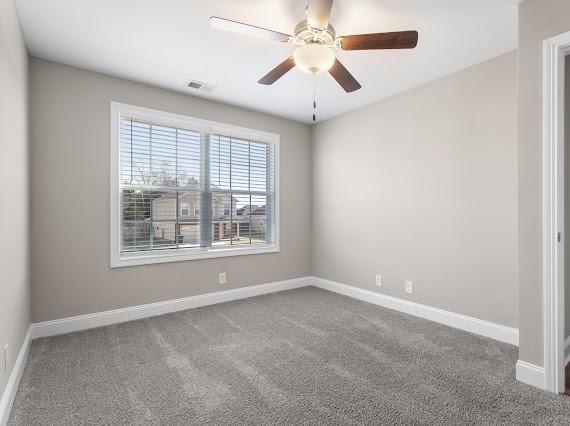 carpeted empty room with ceiling fan