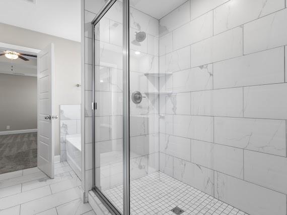 bathroom featuring independent shower and bath and ceiling fan