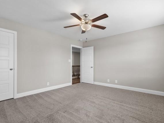 spare room with carpet floors and ceiling fan