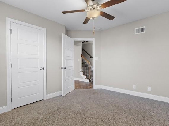 unfurnished bedroom with carpet floors and ceiling fan