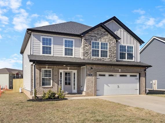 view of front of house featuring a garage and a front lawn