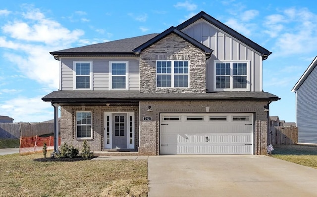 view of front of property featuring a garage and a front lawn