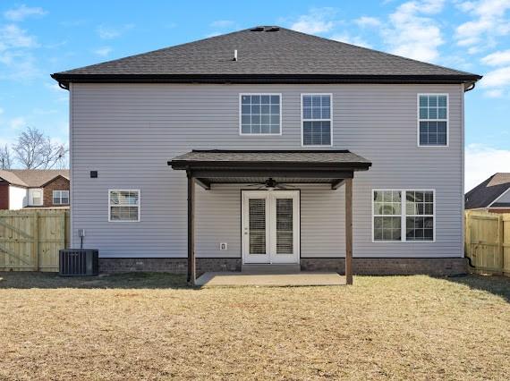 back of house featuring central AC, a patio area, ceiling fan, and a lawn