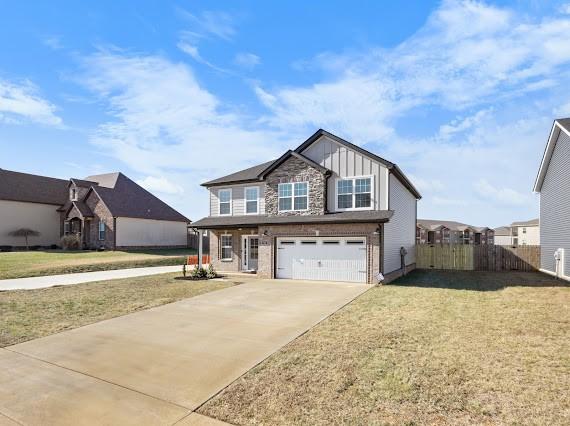 view of front of home with a garage and a front lawn