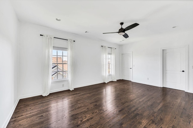 unfurnished room featuring ceiling fan and dark wood-type flooring