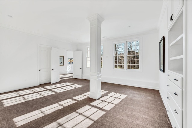 unfurnished living room with dark colored carpet, decorative columns, and ornamental molding