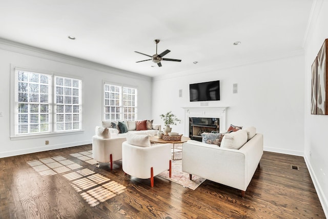 living room featuring dark hardwood / wood-style floors, a wealth of natural light, crown molding, and ceiling fan